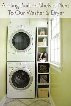 a washer and dryer in a small room next to a shelf with baskets