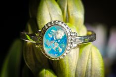 This beautiful .925 sterling silver ring has been filled with crushed synthetic opal and infused with cremation ash of your loved one, making it a lovely way to keep them close to your heart. Shown in White & Lavender, Turquoise & Light Blue, and Black & Dusk Blue The color choice refers to the crushed synthetic opal mix. We can accommodate up to three colors at maximum, but we recommend selecting two. Pictured is a chart with a few of our most popular color combinations. HOW IT’S MADE Your love Cremation Ring, Ashes Ring, Dusk Blue, Pet Memorial Jewelry, White Lavender, Ring Opal, Braided Ring, Cremation Ashes, Synthetic Opal