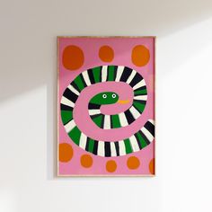 a pink and green painting hanging on the wall next to a white wall with polka dots