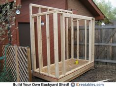 a small wooden structure sitting in the middle of a yard