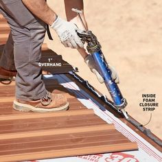 a man is working on the side of a building with some tools attached to it