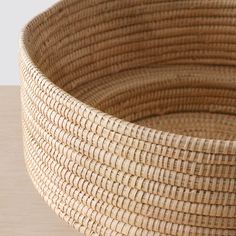 a woven basket sitting on top of a wooden table