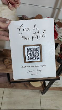 a person holding up a qr code brochure