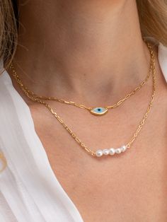 An evil eye necklace in gold color and oval shape and a longer necklace with five tiny freshwater pearls that are made both of them from sterling silver 925 in Greece. You can wear them together or separetely as well. In Christina Christi Jewels store you can see more than 100 designs in Women's Necklaces. You can have them in 2-4 Days with DHL EXPRESS SHIPPING MATERIALS - Gold Plated Chains made from Sterling Silver 925. - Five freshwater Pearls. - Evil eye is made from mother pearl. DIMENSIONS Danty Necklace, Gold Key Necklace, Gold Evil Eye Necklace, Tiny Pearl Necklace, Evil Eye Necklace Gold, Women Necklaces, Dainty Necklaces, Choker Pendant, Diamond Solitaire Necklace