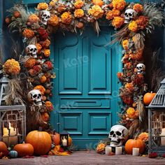 a blue door decorated with pumpkins and skulls, candles and fake flowers for halloween