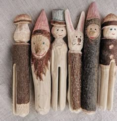 five wooden peg dolls are lined up in a row