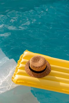 a straw hat sitting on top of an inflatable raft