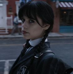 a woman with braids standing on the street