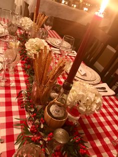 the table is set for christmas dinner with red and white checkered tablecloths