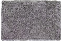 a gray rug with shaggy edges