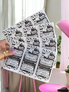 a person holding up some black and white stickers