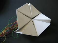 an origami object with wires attached to it