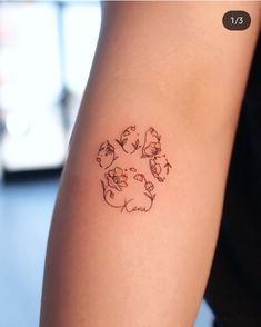 a person with a tattoo on their arm that has cats and dogs in the center