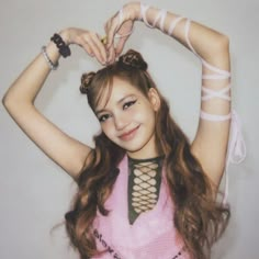 a young woman with long hair and bracelets on her head is posing for the camera