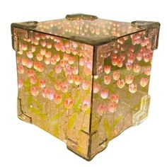 a glass box with flowers painted on it