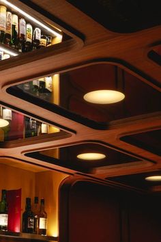 the lights are on above the shelves in the bar