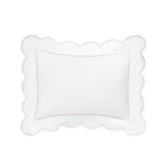 a white pillow with scalloped edges