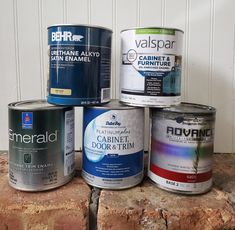 several paint cans are stacked on top of each other