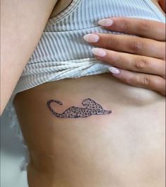 a woman's stomach with a cheetah tattoo on it