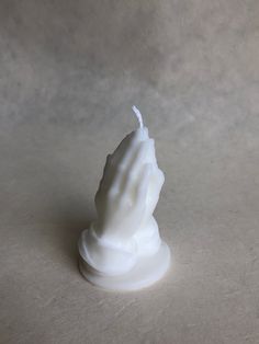 a small white candle sitting on top of a table