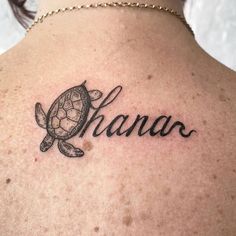 a woman with a tattoo on her back that says hanaa and a turtle swimming in the water