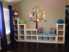 a child's playroom with bookshelves and toys on the shelves in it