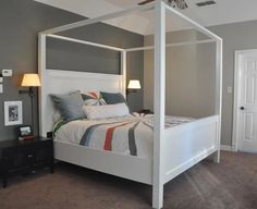 a bedroom with a bed, nightstand and ceiling fan