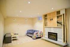 an unfinished room with a bed, desk and fireplace in the middle is being remodeled