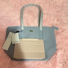 Bnwt Lacoste Small Zip Tote Color Please See Photo Light Blue/Skyblue Dimensions: L5.9 X H6.6 X D1.9" / L15 X H17 X D5 In One Interior Zip Net Pocket With Hook Embroidered Crocodile Branding Dimensions 24 X 24.5 X 14.5 Cm Exterior In Pvc Outside: Pvc (100%) Lacoste Bag Women, Lacoste Bag, Tote Bag Outfit, Uni Bag, University Bag, Photo Light, Lacoste Women, Girls Tote, Blue Handbags