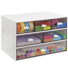 three drawers with different colored labels and tape on them, each containing file folders