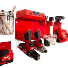 a red tool box with tools in it and some other items on the table next to it