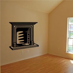 an empty room with a fireplace wall decal