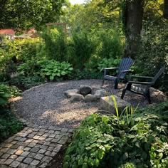 there is a chair in the middle of this garden with rocks and gravel around it