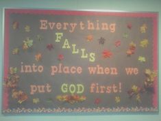 a bulletin board with fall leaves on it and the words everything falls into place when we put god first