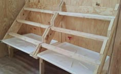 two wooden shelves sitting next to each other on top of plywood boards in a room