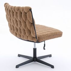 a brown chair sitting on top of a black metal base with an upholstered seat