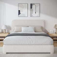 a white bed with two pictures above it