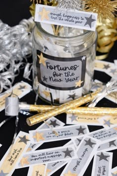 new year's fortune telling jar with confetti sticks in it and gold stars