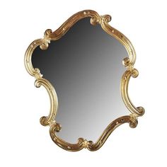 an ornate gold framed mirror on a white background