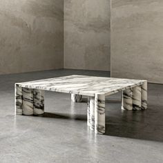 a marble coffee table sitting in an empty room