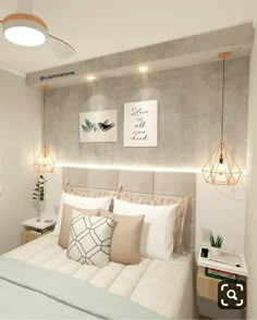 a bedroom with a bed, nightstands and two lamps on the wall above it