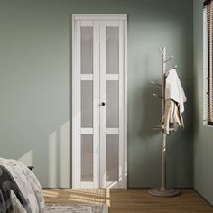 a bedroom with green walls and white furniture, including a door to another room that has an open window