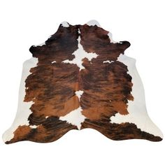 a brown and white cowhide rug on a white background