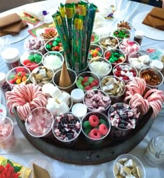 a table topped with lots of different types of candy and candies on top of it