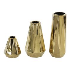 three gold vases sitting next to each other