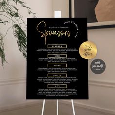 a black and gold wedding ceremony sign on a white easel next to a potted plant