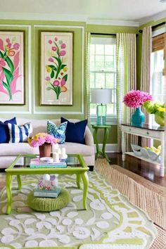 a living room filled with furniture and paintings on the wall above it's coffee table