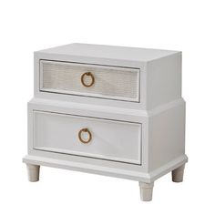 a white nightstand with two drawers and gold knobs on the bottom, against a white background