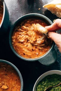 someone is dipping some bread into their soup