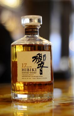 a bottle of whisky sitting on top of a wooden table